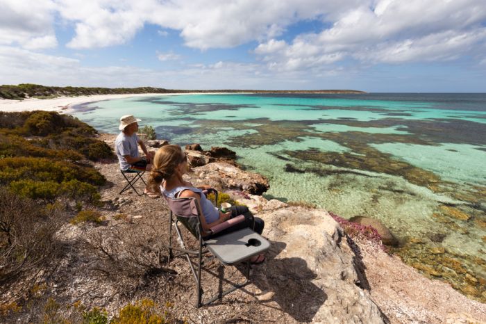 Couple enjoying sitting on camping chair